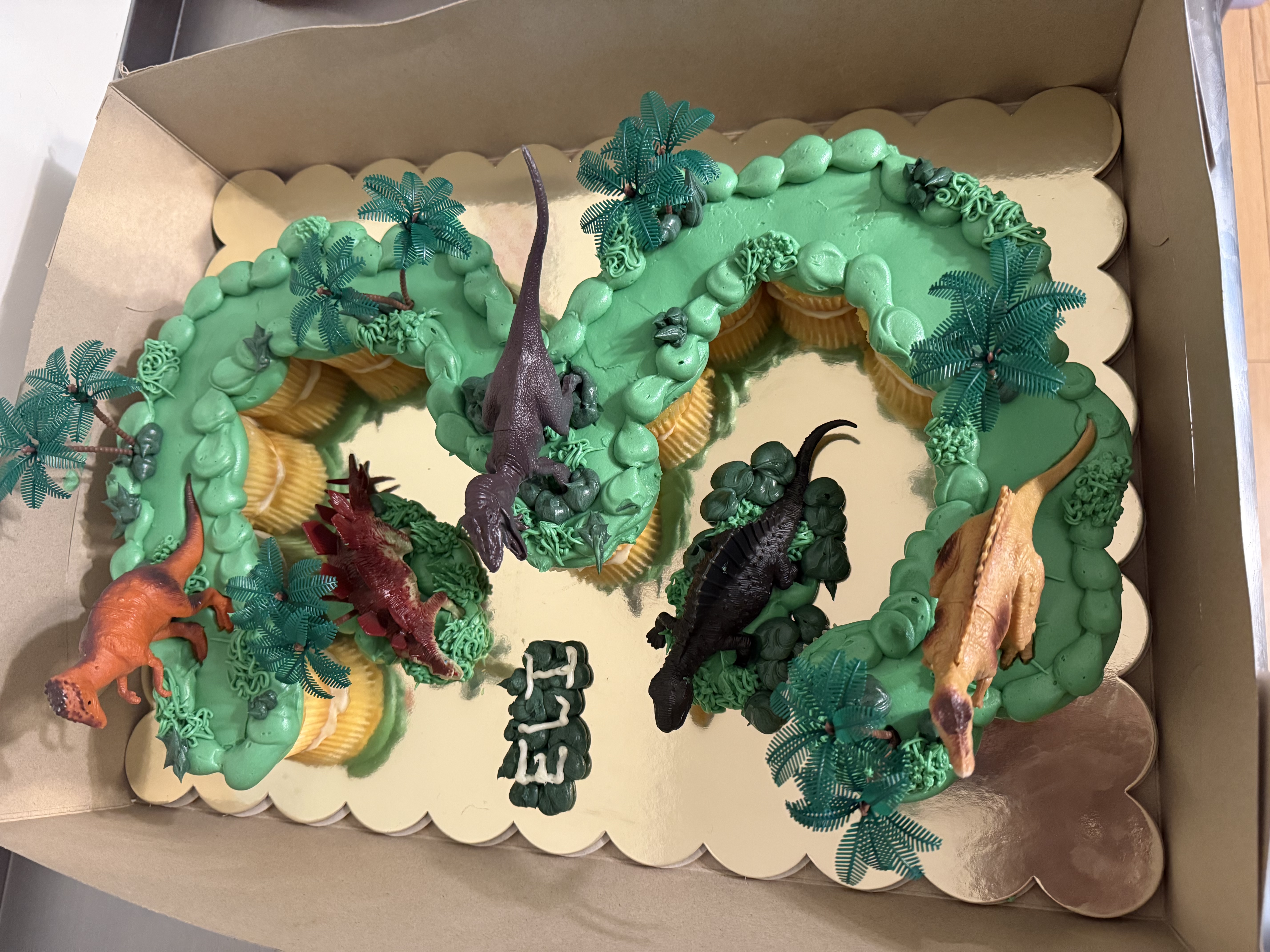 Green dinosaur number-shaped birthday cake